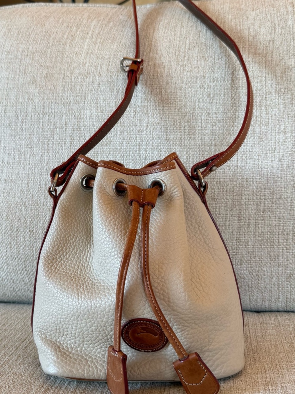 Dooney & Bourke Cream and Tan Pebbled Leather Drawstring Crossbody